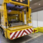 【画像】【ハイウェイテクノフェア2024】車線制限の矢印表示板を設置、回収する作業車が凄い。表示板を反転させる訳は？ 〜 画像3